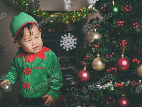 Preview: Baby Girl Decorating Christmas Tree