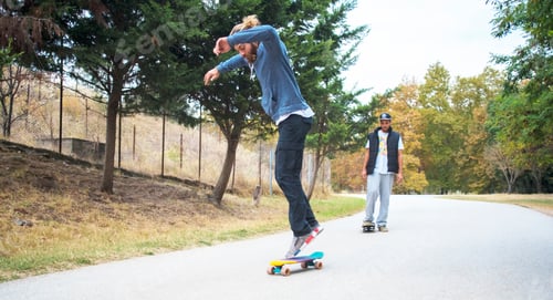 Preview: Happy Young Skateboarder Having Fun With Skateboard On The Road