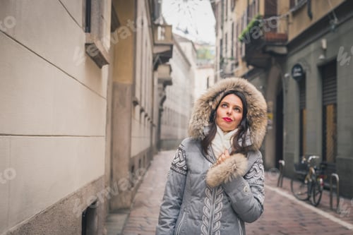 Preview: Beautiful Young Brunette With Furry Hood Posing In The City Streets