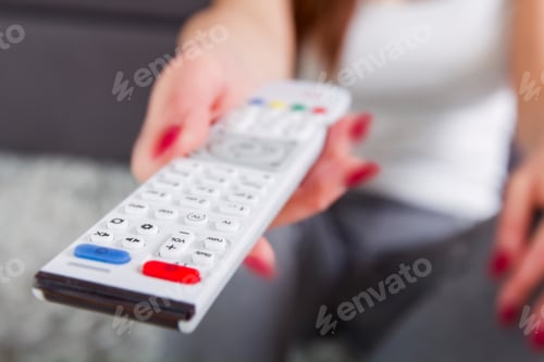 Preview: Television Remote Control In Woman Hand. Unrecognizable Person.