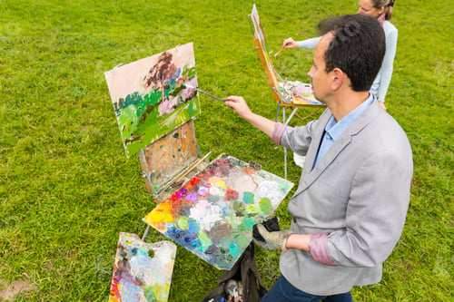 Preview: Couple Of Middle-Aged Fashionable Professional Artists Working On A Sketchbook Painting A Garden