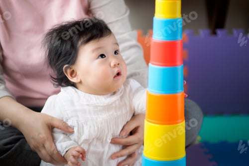 Preview: Asian Baby Girl Playing Stacking Cups