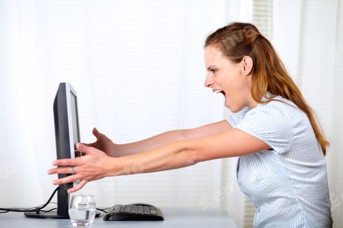 Preview: Portrait Of A Excited Blonde Girl Screaming And Celebrating A Victory At Workplace