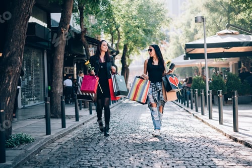 Preview: Two Female Friends With Shopping Bags Walking The City Streets