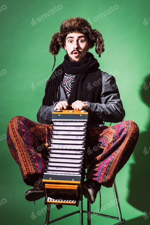 Preview: Positive Man With Accordion Posing In Studio