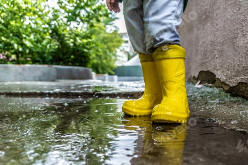 Preview: Little Baby Is Standing In A Puddle In Rubber Boots
