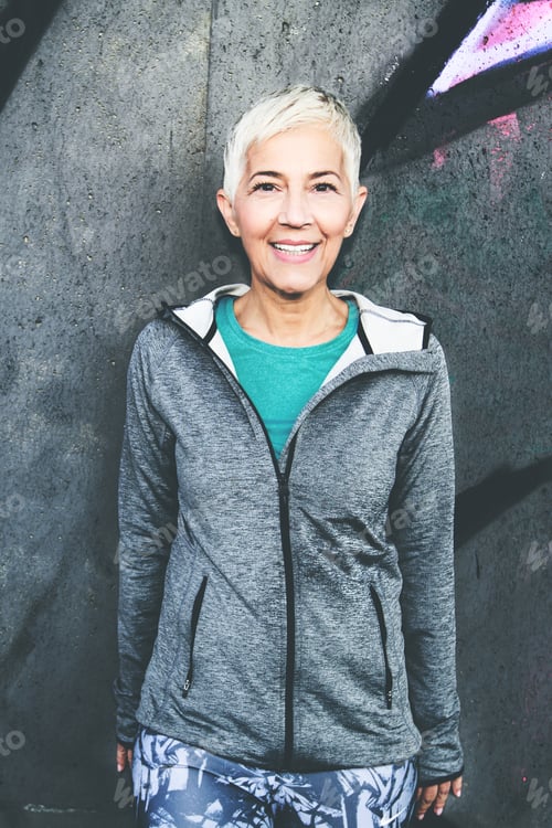 Preview: Senior Woman Relax After Running, Leaning On Concrete Wall. Short Hair, Sports Clothes , Looking At