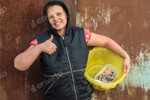 Preview: A Young Girl Hangs Wet Clothes On A Rope To Dry. She Lifted Her Thumb And Showed That She Was Doing