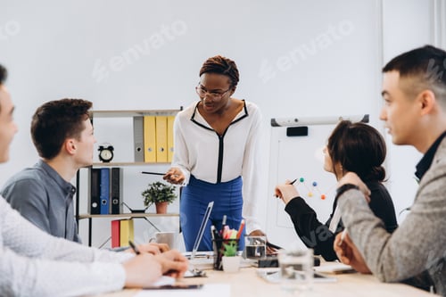 Preview: Group Of Multicultural Businesspeople Listening Their Boss Speech - African American Woman Manager
