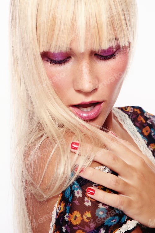 Preview: Beautiful Young Blond Girl Looking At Her Sun-Bleached Hair With Worried Expression