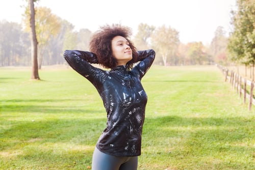 Preview: Sporty Girl Exercise At Park On Green Fields In The Morning. Copy Space For Motivation Quote.