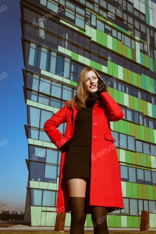 Preview: Beautiful Girl With Red Coat Talking On Phone In The Street
