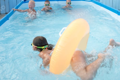 Preview: Funny Young Girl And Boys In Rainbow Glasses For Swimming Play In Blue Water Of Frame Pool