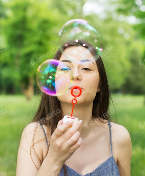 Preview: Young Woman Blowing Bubbles Outdoor. Caucasian Female Relaxing Lifestyle In The Park.