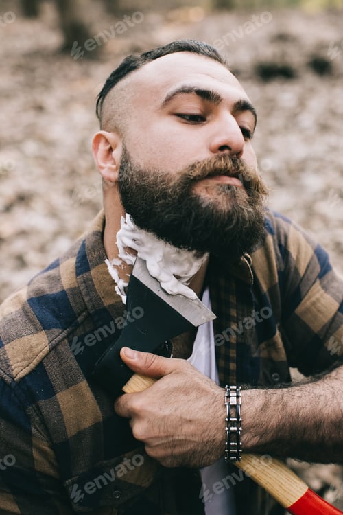 Preview: Bearded Man Shaving With An Ax