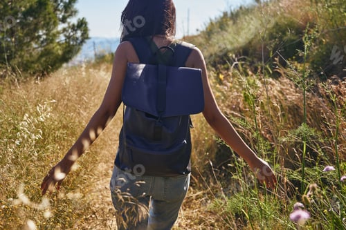 Preview: A Free Young Lady Walking Through Nature While Running Her Fingers Through The Wild Flora