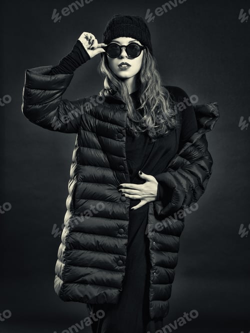 Preview: Stylish Young Woman In A Down Coat And Knit Cap.