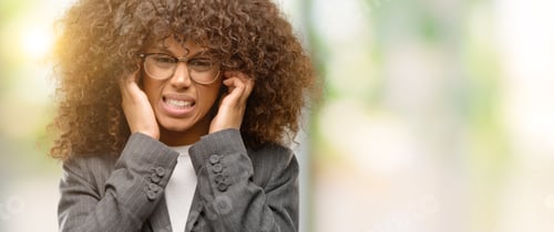 Preview: African American Business Woman Wearing Glasses Covering Ears With Fingers With Annoyed Expression