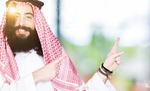 Preview: Arabian Business Man With Long Hair Wearing Traditional Keffiyeh Scarf Smiling And Looking At The
