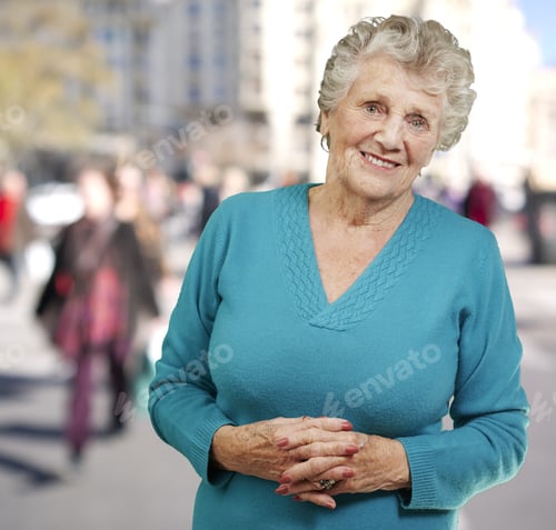 Preview: Portrait Of Senior Woman Standing At Crowded Place