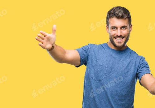 Preview: Young Handsome Man Over Isolated Background Looking At The Camera Smiling With Open Arms For Hug
