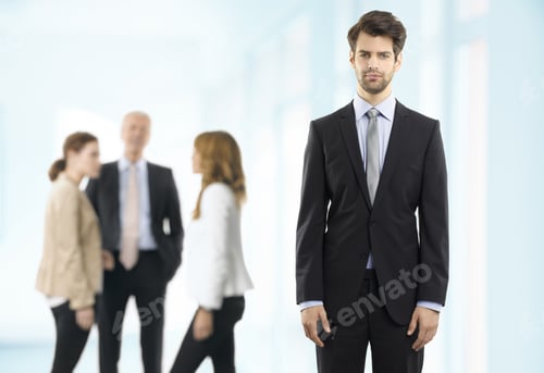 Preview: Portrait Of Executive Young Businessman Standing At Office Background With Colleagues. Business