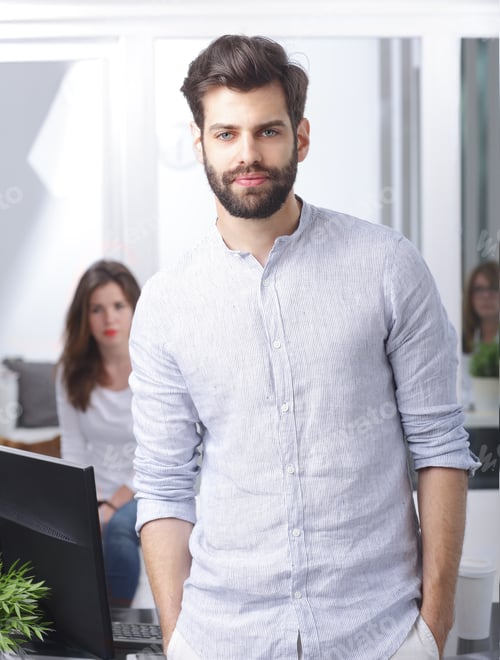 Preview: Portrait Of Smiling Young Businessman Standing At Office While Looking At Camera And Smiling
