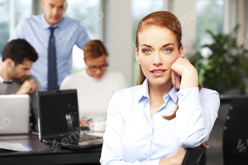 Preview: Close-Up Portrait Of Attractive Middle Age Businesswoman Sitting At Foreground While Business Team