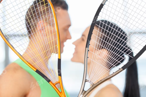 Preview: Fitness Couple. Loving Couple Kissing Behind Tennis Racket