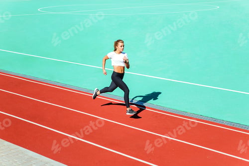 Preview: Young Female Jogger Running At Stadium