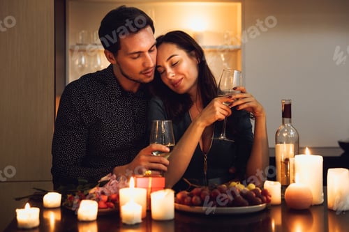 Preview: Beautiful Passionate Couple Having A Romantic Candlelight Dinner At Home, Drinking Wine, Toasting