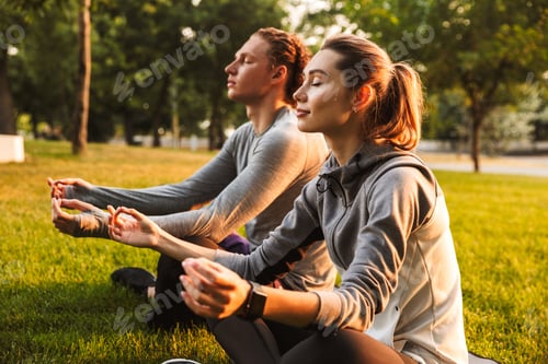Preview: Image Of Concentrated Fitness Sport Loving Couple Friends In Park Outdoors Make Meditate Exercises.
