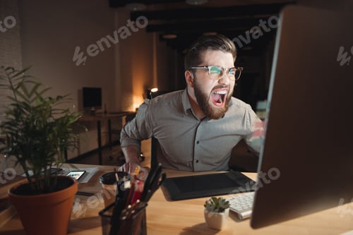 Preview: Picture Of Angry Web Designer Dressed In Shirt And Wearing Eyeglasses Working Late At Night And