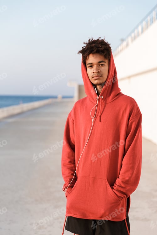 Preview: Image Of A Young Sports African Guy Outdoors On The Beach Looking Camera.