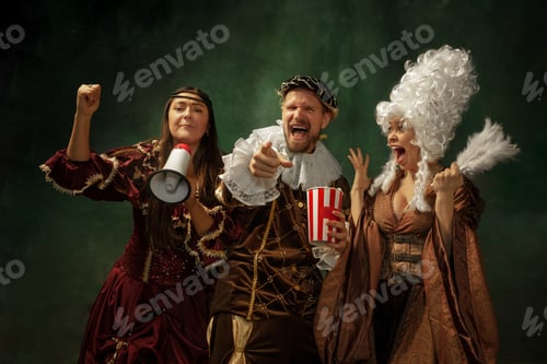 Preview: Real Sport Fans. Portrait Of Medieval Young People In Vintage Clothing On Dark Background. Models