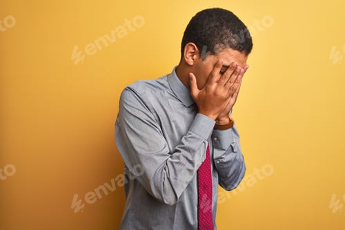 Preview: Young Handsome Arab Businessman Wearing Shirt And Tie Over Isolated Yellow Background With Sad