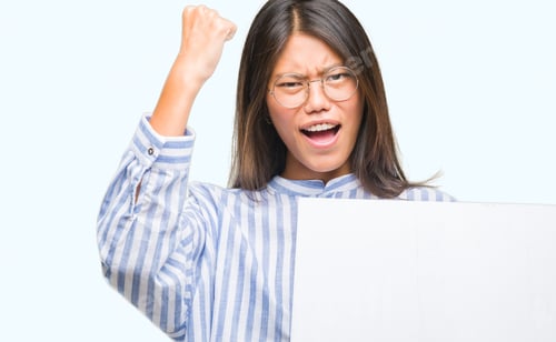 Preview: Young Asian Woman Over Isolated Background Holding Blank Banner Annoyed And Frustrated Shouting