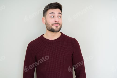Preview: Young Handsome Man Wearing A Sweater Over Isolated Background Smiling Looking Side And Staring Away