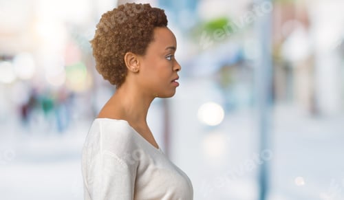 Preview: Young African American Woman Over Isolated Background Looking To Side, Relax Profile Pose With