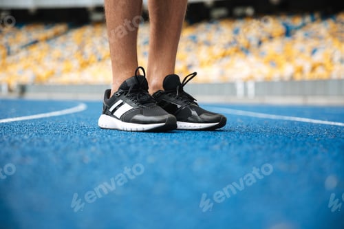 Preview: Close Up Of A Male Legs In Sneakers Standing At The Racetrack