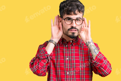 Preview: Young Handsome Man Wearing Glasses Over Isolated Background Trying To Hear Both Hands On Ear