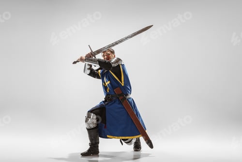 Preview: Brave Armored Knight With Professional Weapon Fighting Isolated On White Studio Background
