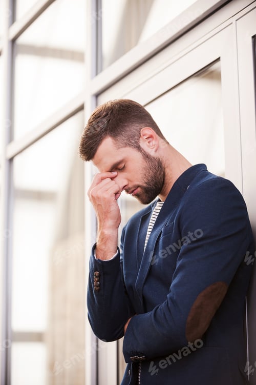 Preview: Sick And Tired. Frustrated Young Man In Smart Casual Wear Touching His Face With Hand And Keeping
