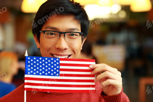 Preview: Happy Asian Student Holding Flag Of Usa