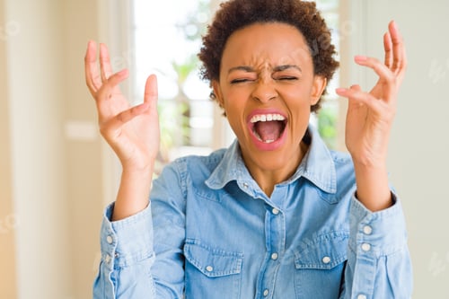Preview: Young Beautiful African American Woman Celebrating Mad And Crazy For Success With Arms Raised And