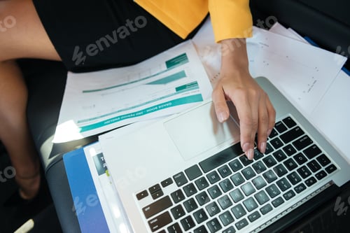 Preview: Cropped Image Of A Female Hands Working With Laptop And Documents