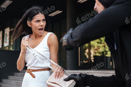 Preview: Angry Young Woman Shouting And Protecting From Man Thief With Gun On The Street