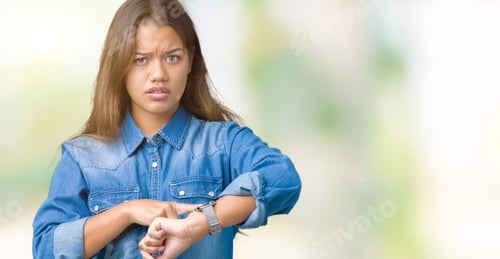 Preview: Young Beautiful Brunette Woman Wearing Blue Denim Shirt Over Isolated Background In Hurry Pointing