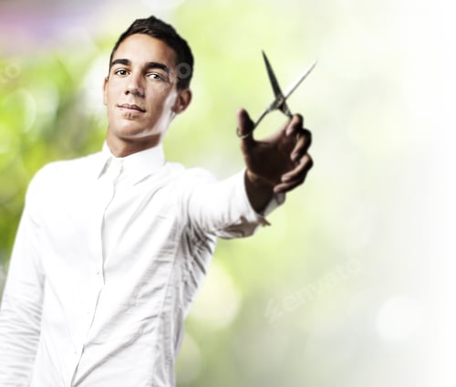 Preview: Portrait Of Young Man With Scissors Against A Plants Background