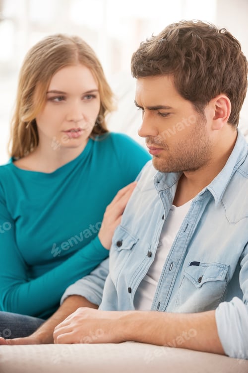 Preview: Relationship Difficulties. Depressed Young Man Sitting On The Couch And Looking Upset While Young